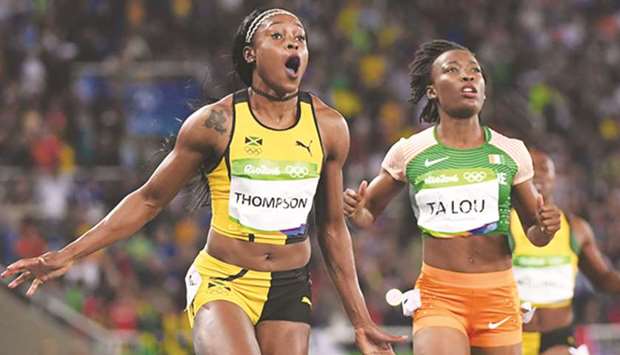 In this August 13, 2016, picture, Elaine Thompson (left) of Jamaica celebrates her victory in the womenu2019s 100m final at the 2016 Olympic Games as Marie-Josee Ta Lou of Ivory Coast looks on at the Olympic Stadium in Rio de Janeiro, Brazil. (AFP/Getty Images)