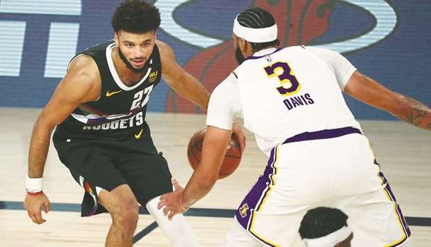 Denver Nuggets guard Jamal Murray (left) dribbles the ball against Los Angeles Lakers forward Anthony Davis during the second half of game three of the Western Conference Finals of the 2020 NBA Playoffs at AdventHealth Arena. (USA TODAY Sports)