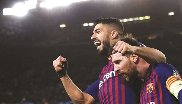 In this file photo taken on March 13, 2019, Barcelonau2019s Argentinian forward Lionel Messi (right) celebrates with Barcelonau2019s Uruguayan forward Luis Suarez after scoring during their UEFA Champions League round of 16 second leg match between against Olympique Lyonnais at the Camp Nou Stadium in Barcelona. (AFP)