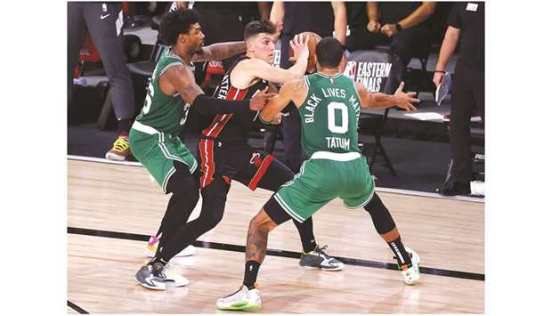 Tyler Herro of the Miami Heat looks to pass against Jayson Tatum (right) and Marcus Smart (left) of the Boston Celtics during the fourth quarter in Game Four of the Eastern Conference Finals during the 2020 NBA Playoffs at AdventHealth Arena at the ESPN Wide World Of Sports Complex on September 23, 2020, in Lake Buena Vista, Florida. (Getty Images/AFP)
