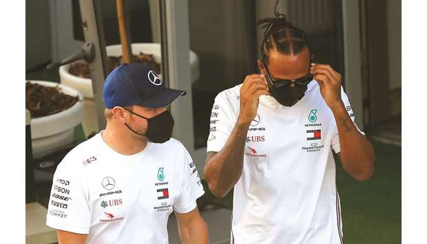 Mercedes drivers Lewis Hamilton (right) and Valtteri Bottas walk through the paddock ahead of the Russian Grand Prix in Sochi yesterday. (Reuters)