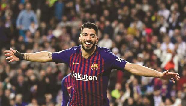 In this file photo taken on February 27, 2019, Barcelonau2019s Uruguayan forward Luis Suarez celebrates his second goal during the Spanish Copa del Rey (Kingu2019s Cup) semi-final second leg match against Real Madrid at the Santiago Bernabeu Stadium in Madrid. (AFP)