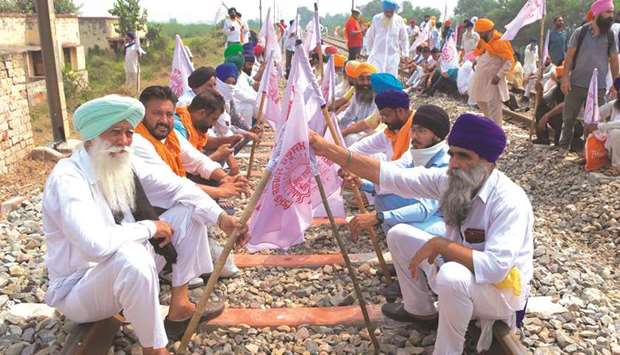 Farmers block train tracks during a protest against Prime Minister Narendra Modi following the recent passing of agriculture bills in the Lok Sabha, at Devi Dasspura village some 25kms from Amritsar yesterday.