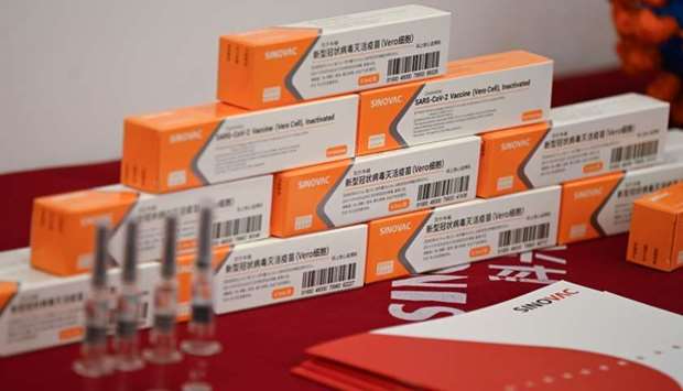 Sinovac Biotech vaccines, one of 11 Chinese companies approved to carry out clinical trials of potential coronavirus vaccines, are displayed at a press conference during a media tour of a new factory built to produce Covid-19 coronavirus vaccines, in Beijing