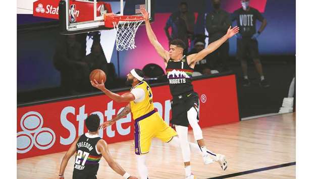LA Lakers forward Anthony Davis (centre) shoots past Denver Nuggets forward Michael Porter Jr. (right) during Game Four of the Western Conference Finals of the 2020 NBA Playoffs in Lake Buena Vista, Florida, United States, on Thursday. (USA TODAY Sports)
