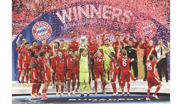 Bayern Munich players celebrate with the trophy after winning the UEFA Super Cup match against Sevilla FC at the Puskas Arena in Budapest, Hungary. (AFP)