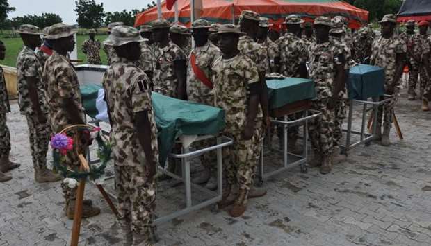 Nigerian soldiers stand on attention during the funeral of the soldiers killed in the attack on vehicles carrying Borno governor Babagana Umara Zulum near the town of Baga on the shores of Lake Chad.