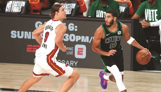 Boston Celtics forward Jayson Tatum (right) moves the ball against Miami Heat forward Kelly Olynyk during the first half in game five of the Eastern Conference Finals of the 2020 NBA Playoffs at AdventHealth Arena in Lake Buena Vista, Florida. (USA TODAY Sports)