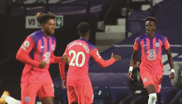 Chelseau2019s English striker Tammy Abraham (right) celebrates with teammate Callum Hudson-Odoi (centre) after scoring their third goal during the English Premier League match against West Bromwich Albion at the Hawthorns Stadium in West Bromwich, central England, yesterday. (AFP)