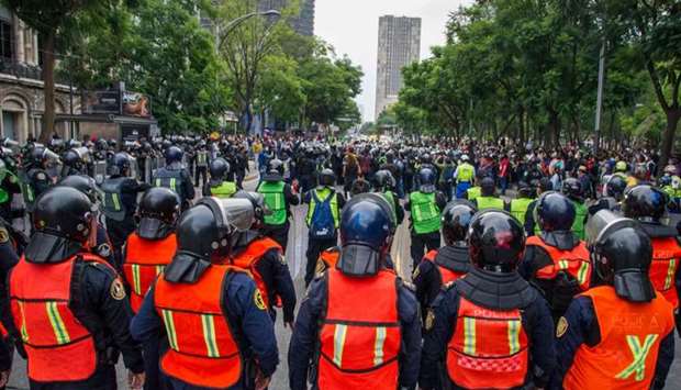 Demonstrators confront riot police in Mexico City yesterday during a march for the sixth anniversary of the disappearance of 43 students of the Ayotzinapa Teacher Training College