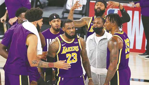 LeBron James (centre) of the Los Angeles Lakers celebrates with teammates after their win against the Denver Nuggets in Game Five of the Western Conference Finals during the 2020 NBA Playoffs in Lake Buena Vista, Florida, United States, on Saturday. (AFP)