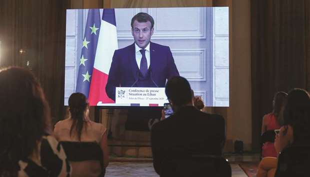 French President Emmanuel Macron addresses Lebanese journalists during a virtual press conference broadcast at the Pine Residence, the official residence of the French ambassador, in the capital Beirut, yesterday.