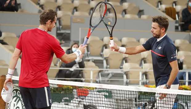 Britainu2019s Andy Murray (L) congratulates Switzerlandu2019s Stan Wawrinka after their first round match in the French Open yesterday.