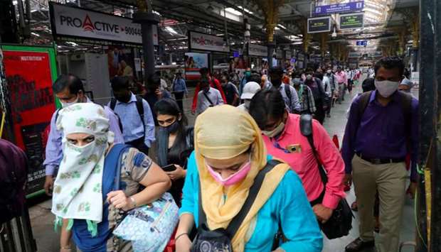 People wearing protective face masks leave the Chhatrapati Shivaji Terminus railway station.