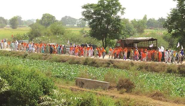 Farmers shout slogans as they arrive to block railway tracks during a protest against the central government following the passing of new farm bills, on the outskirts of Amritsar in Punjab yesterday.