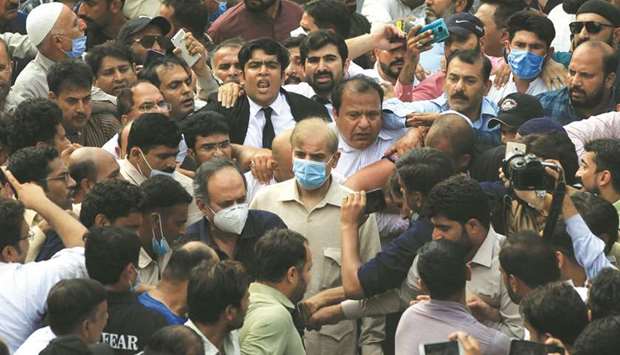 Opposition Leader and PML-N president Shehbaz Sharif is seen with lawyers and supporters after the Lahore High Court rejected his bail plea in a money laundering case.