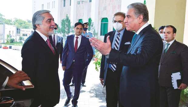 This handout picture taken and released by the Pakistan ministry of foreign affairs shows chairman of the High Council for National Reconciliation of Afghanistan, Dr Abdullah Abdullah, being welcomed by Foreign Minister Shah Mahmood Qureshi at the ministry in Islamabad.