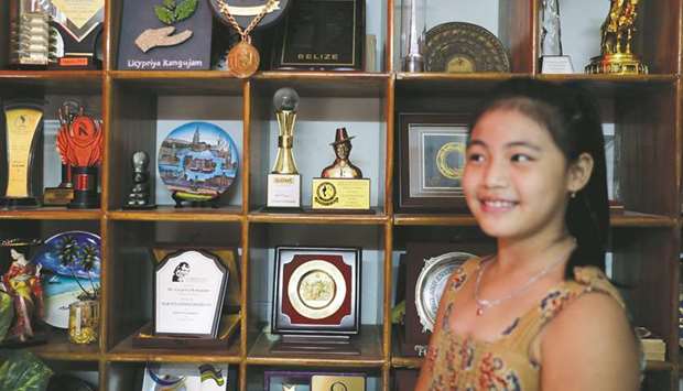 Licypriya Kangujam poses in front of her trophies at her house in Noida.