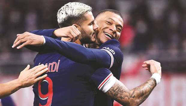 Paris Saint-Germainu2019s Argentinian forward Mauro Icardi (left) celebrates with teammate Kylian Mbappe after scoring a goal during the Liague 1 match against Reims at the Auguste Delaune Stadium in Reims, eastern France. (AFP)