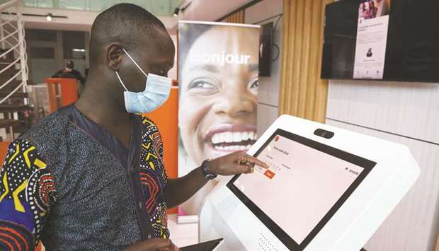 A man performs a financial transaction at a bank of the French mobile operator Orange in Abidjan, Ivory Coast on September 18. Africau2019s mobile phone operators are ramping up plans to bring banking to millions of Africans, in some cases for the first time, after the coronavirus crisis caused a surge in use of digital financial services.