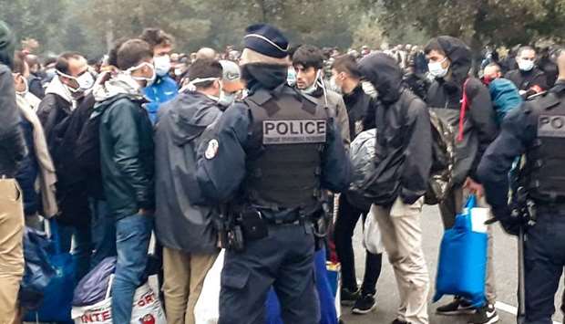 French police evacuate some 800 migrants after they dismantled their camp located near the hospital in Calais, northern France