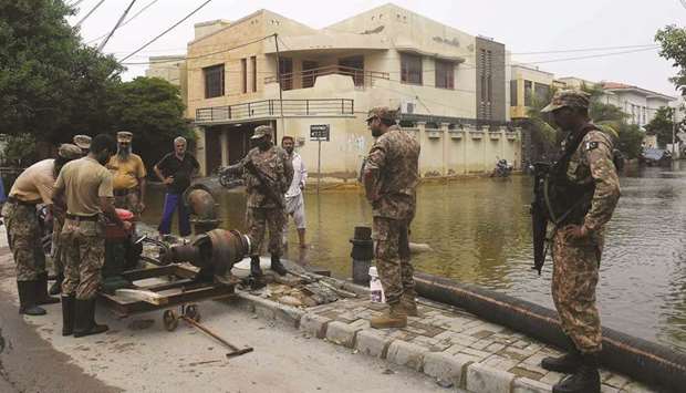 This picture taken late last month shows troops installing a water pump to remove water from a flooded residential area in Karachi.