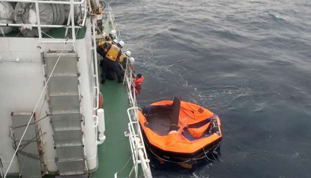 Filipino crew member of Gulf Livestock 1 is rescued by Japan Coast Guard crew on vessel Kaimon, at the East China Sea