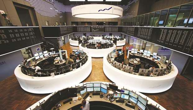 Traders monitor data on computer screens at the Frankfurt Stock Exchange. The DAX 30 closed down 0.5% to 12,992.67 points yesterday.