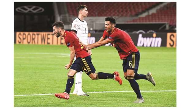 Spainu2019s defender Jose Luis Gaya Pena (left) is congratulated by midfielder Mikel Merino after scoring during the UEFA Nations League match against Germany in Stuttgart, southern Germany, on Thursday night. (AFP)