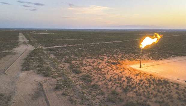 A gas flare burns at dusk in the Permian Basin in Texas (file). Investors managing more than $2tn are calling on Texas regulators to ban the routine burning of natural gas from shale fields, arguing that the energy industry hasnu2019t moved quickly enough to curb the controversial practice.