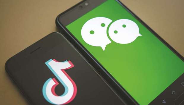 Logs for WeChat app (right) and TikTok app are arranged for a photograph on smartphones in Hong Kong. The most popular Chinese-owned social media from WeChat to TikTok are increasingly censoring content in the US and elsewhere, taking practices honed for years behind the Great Firewall to an international audience.