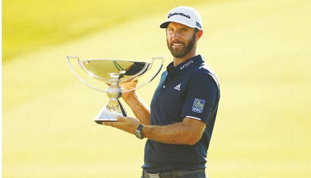 Dustin Johnson of the United States celebrates with the FedEx Cup Trophy after winning in the final round of the Tour Championship at East Lake Golf Club in Atlanta, Georgia. (Getty Images/AFP)