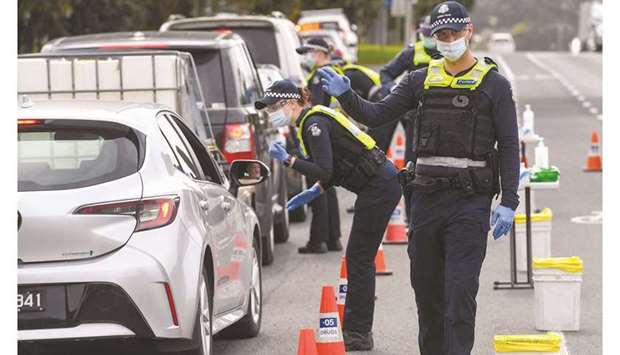 Police check the details of drivers in the small regional town of Kilmore, some 60km north of Melbourne yesterday, to prevent residents of locked-down Melbourne from travelling to Covid-free regions to reduce the transmission of the Delta variant of coronavirus.