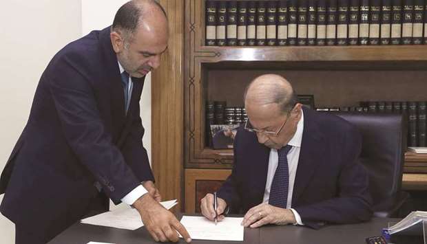 Lebanonu2019s President Michel Aoun signs a decree for the formation of the new Lebanese government at the presidential palace in Baabda, Lebanon, yesterday.