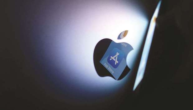 This file illustration photo shows the App Store logo reflected from an iPhone onto the back of an iMac in Los Angeles. Appleu2019s commissions from the App Store generated an estimated $6.3bn last year in the US u2013 with most of it coming from in-app purchases and subscriptions. That money is whatu2019s at stake as games and other apps prepare to steer consumers away from Appleu2019s payment system.