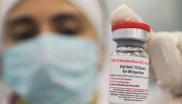 A doctor holds a vial of Chinau2019s Sinovac Covid-19 vaccine at the Holding Company for Biological Products and Vaccines u201cVacserau201d in Cairo (file). More than $20bn that left the country over the past three years as a result of volatility in emerging markets and the impact of the Covid -19 pandemic.