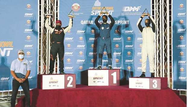 Qatari driver Abdullah al-Kelaifi, winner of the Open Class 1 in the second round of the Qatar National Sprint Championship, celebrates with the rest of the podium winners at the Losail International Circuit on Friday. Mansour Chebli (second left) finished second. Abdulaziz al-Jabri grabbed the third spot.