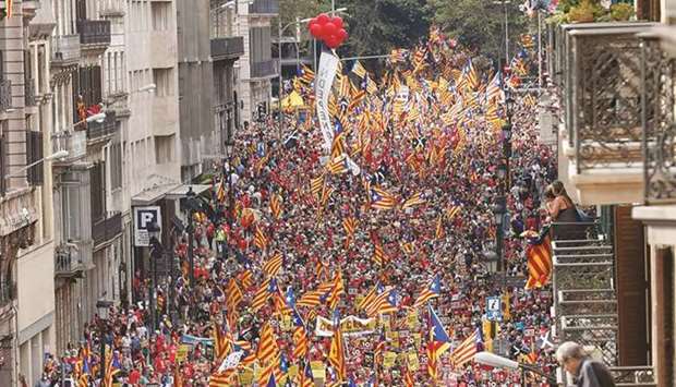 People hold up Esteladas flags (Catalan separatist flag) during Cataloniau2019s national day, u2018La Diadau2019, in Barcelona yesterday.