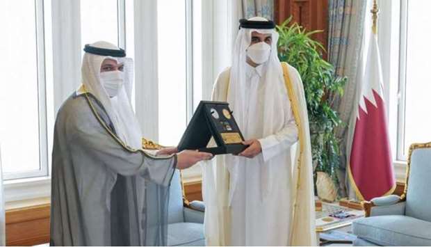The Governor of the Central Bank of Kuwait presented HH the Amir with a commemorative coin issued by the Central Bank of Kuwait .