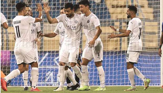 Al Saddu2019s Boualem Khoukhi (centre) celebrates his goal with his teammates during the QNB Stars League match against Al Sailiya on Sunday.