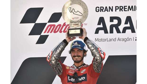 Ducati Lenovo Teamu2019s Francesco Bagnaia celebrates on the podium with the trophy after winning the Aragon Grand Prix in Alcaniz, Spain, yesterday. (Reuters)