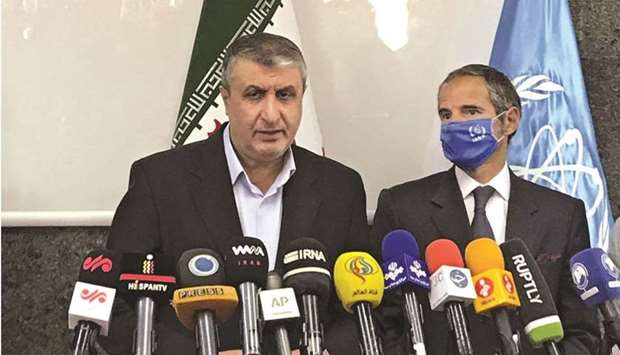 A handout picture provided by Atomic Energy Organisation of Iran (AEOI) yesterday shows Head of the AEOI Mohamed Eslami delivering a speech next to Director-General of the International Atomic Energy Agency (IAEA) Rafael Grossi (right) following their meeting in Tehran.