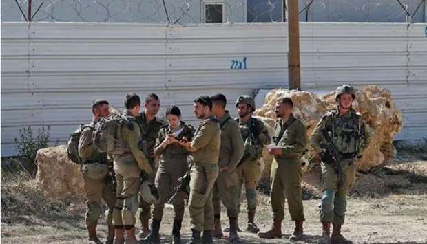 Members of Israeli security forces stand guard near the Palestinian city of Bethlehem in the occupied West Bank.