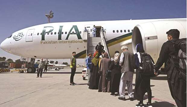 Passengers board the Pakistan International Airlines (PIA) flight at the airport in Kabul.