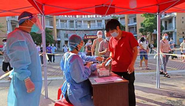 Residents register to take nucleic acid tests at a testing site in Quanzhou, following new cases of the coronavirus disease (COVID-19), in Fujian province, China September 13, 2021.