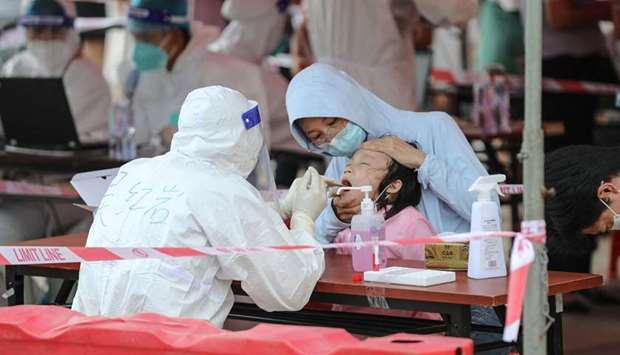 A child undergoes a nucleic acid test for the Covid-19 coronavirus in Xiamen, in China's eastern Fujian province on September 14, 2021.