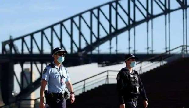(File photo)   Police officers wearing face masks patrol in front of the Harbour Bridge in Sydney. ( AFP )