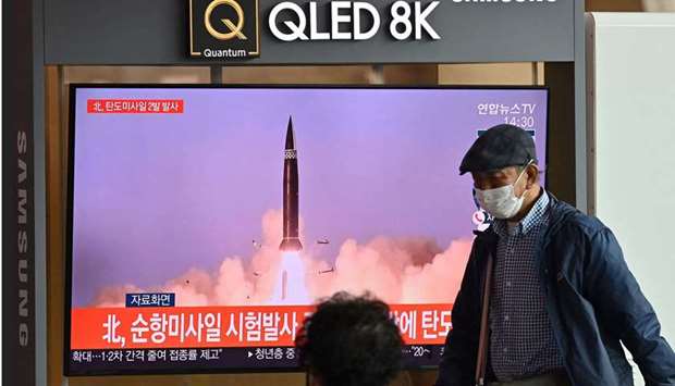 People watch a TV broadcasting file footage of a news report o.n North Korea firing what appeared to be a pair of ballistic missiles off its east coast, in Seoul, South Korea