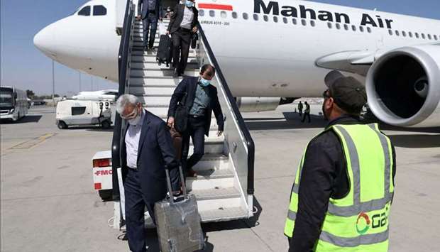 Passengers get off from a privately owned Iranian airline Mahan Air flight at the airport in Kabul on September 15, 2021.