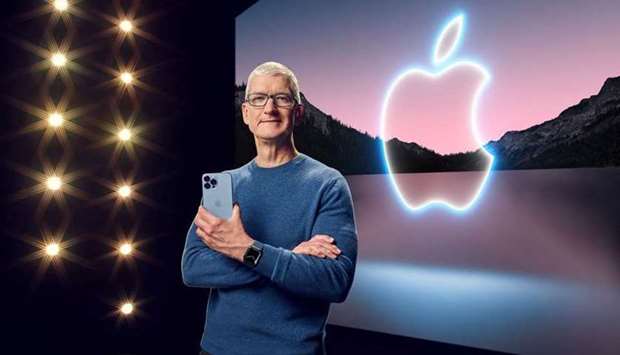 Apple CEO Tim Cook holds the iPhone 13 Pro Max and Apple Watch Series 7 during a special event at Apple Park in Cupertino, California broadcast September 14, 2021. (Apple Inc via REUTERS)
